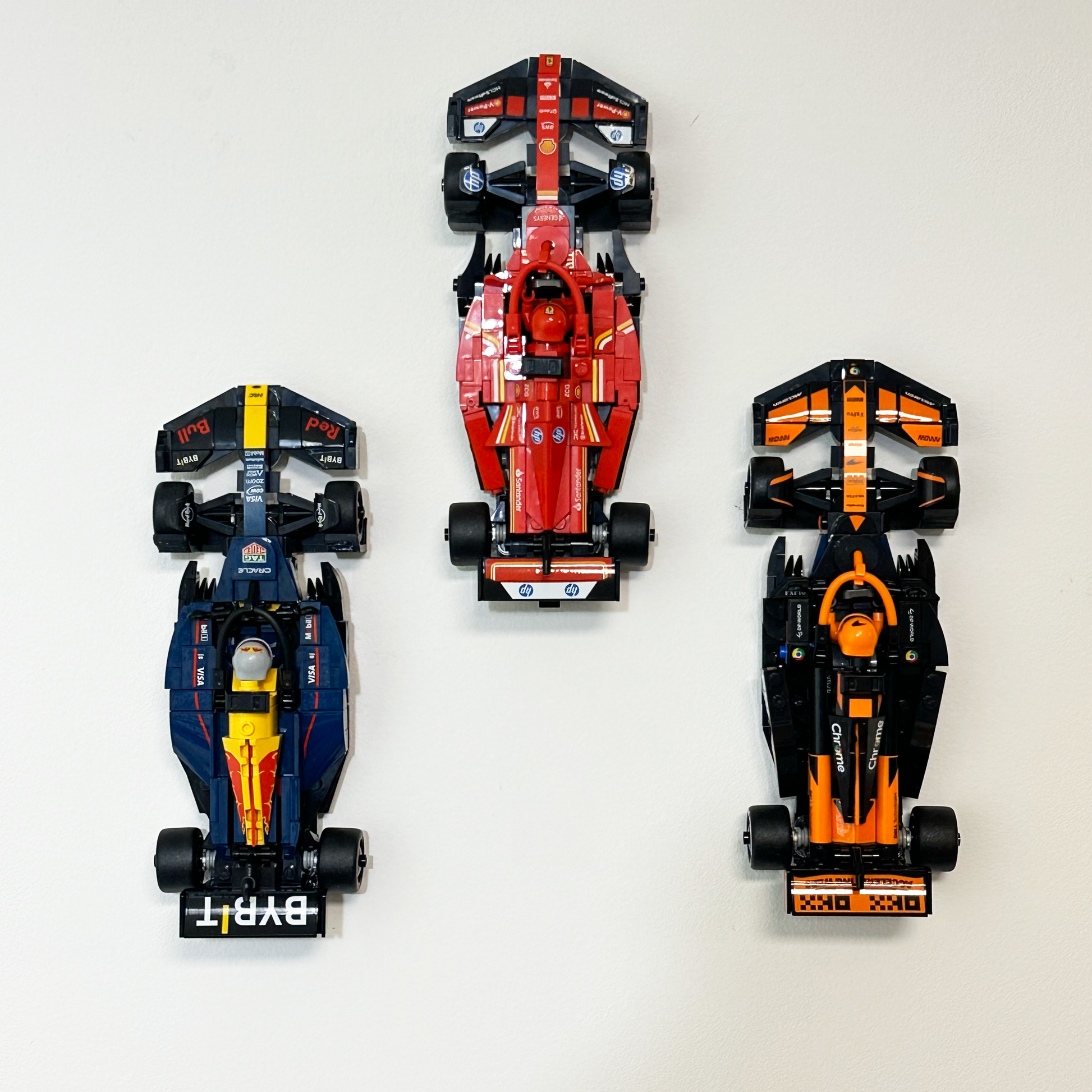 LEGO Speed Champions cars displayed on minimalist 3D-printed wall hooks