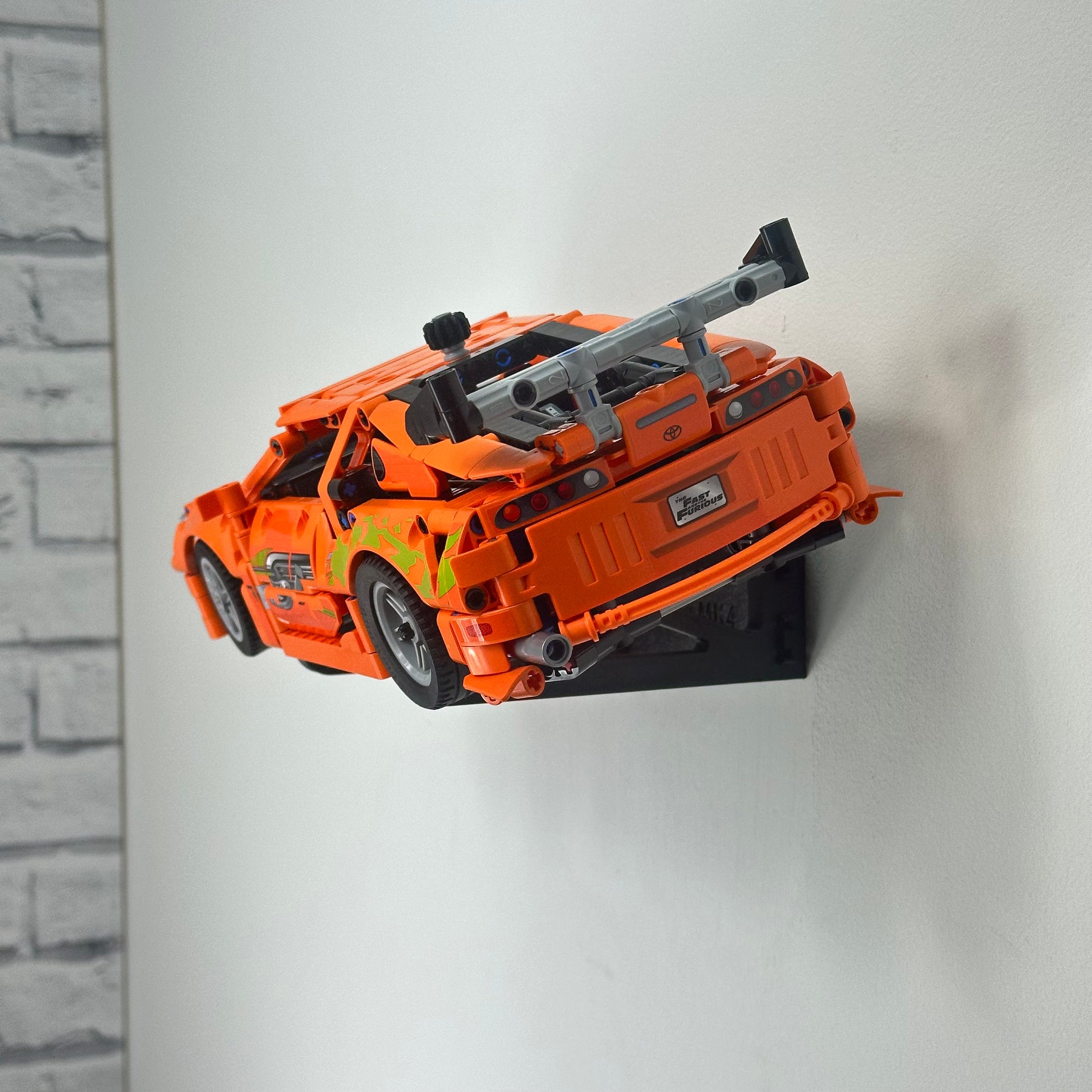 Angled wall display mount holding LEGO Toyota Supra MK4 floating off the wall