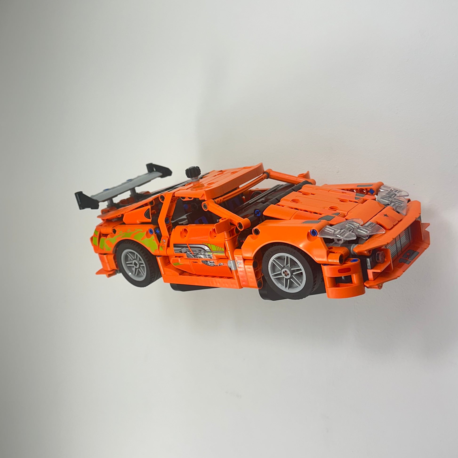 Floating wall-mounted display stand for LEGO Toyota Supra MK4 set 42204