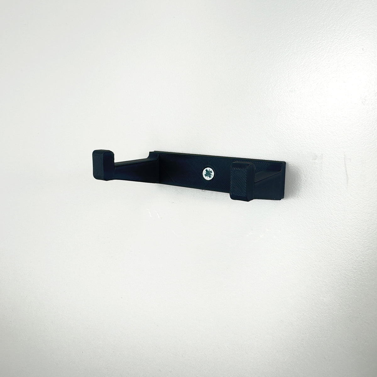 Close-up of the custom black BrickNest wall mount designed for the LEGO BMW M4 GT3 model