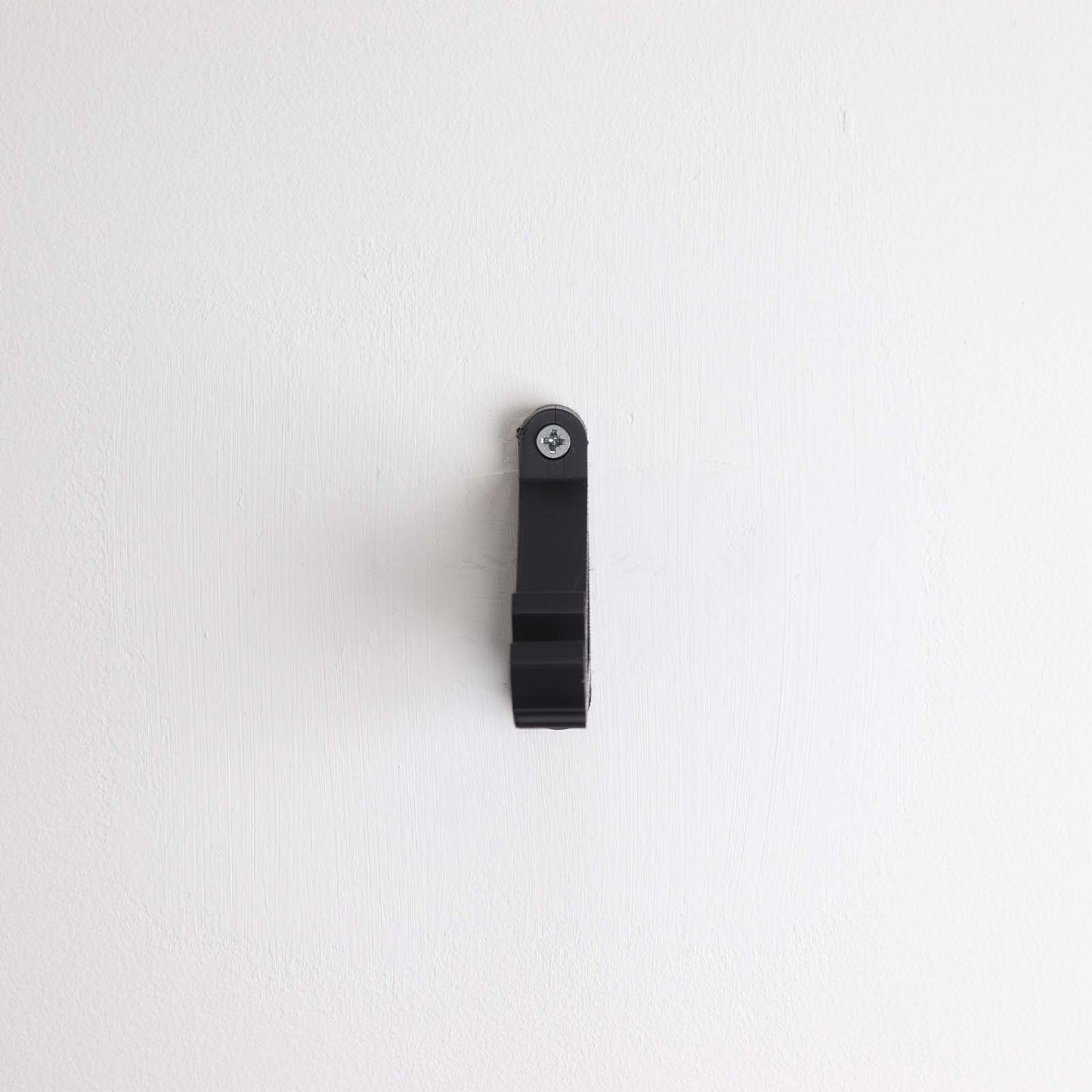 Wall display mount holding LEGO® McLaren Formula E (42169) model, displaying the car at an angled position on the wall for an attractive presentation.