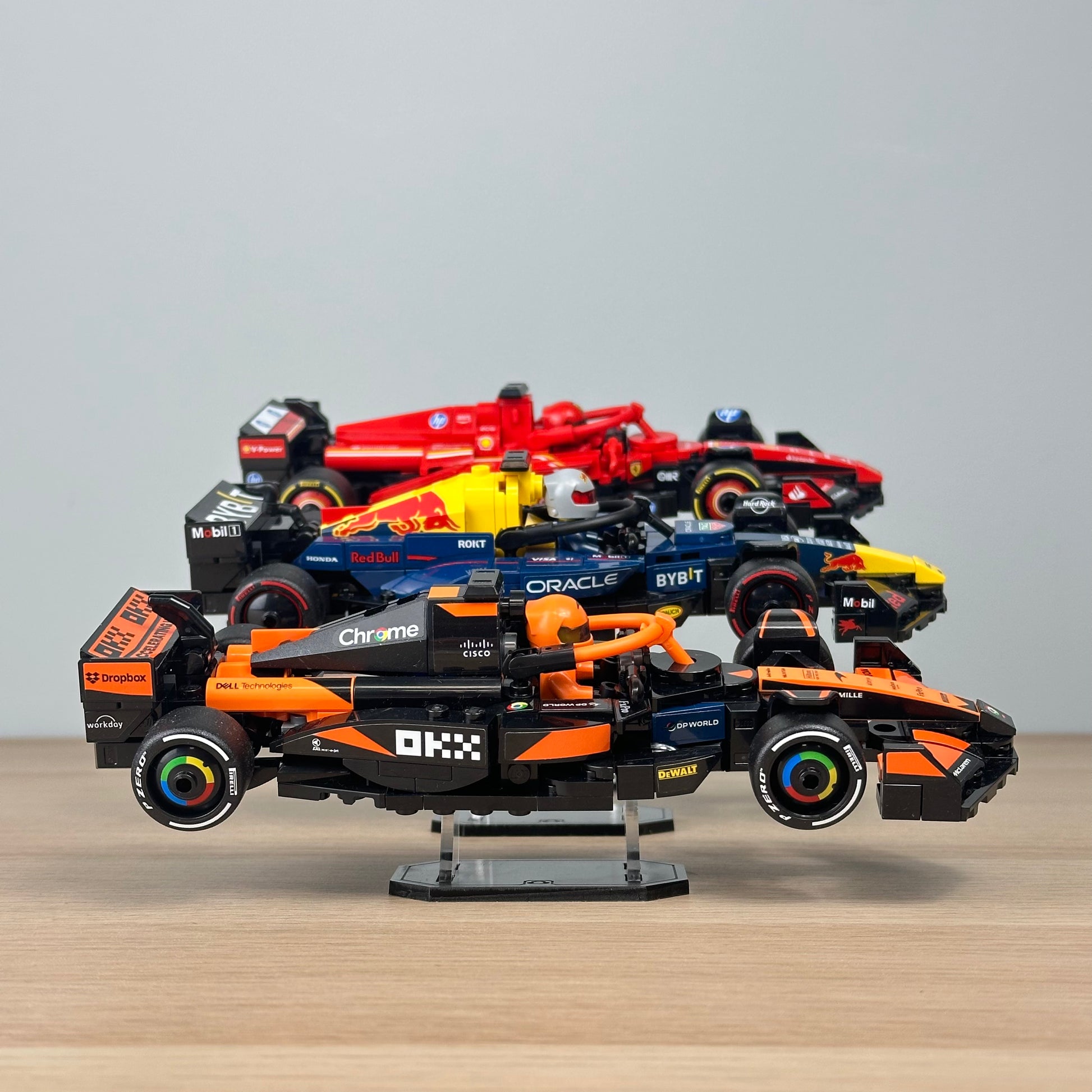 LEGO Speed Champions cars displayed at varying heights on acrylic risers