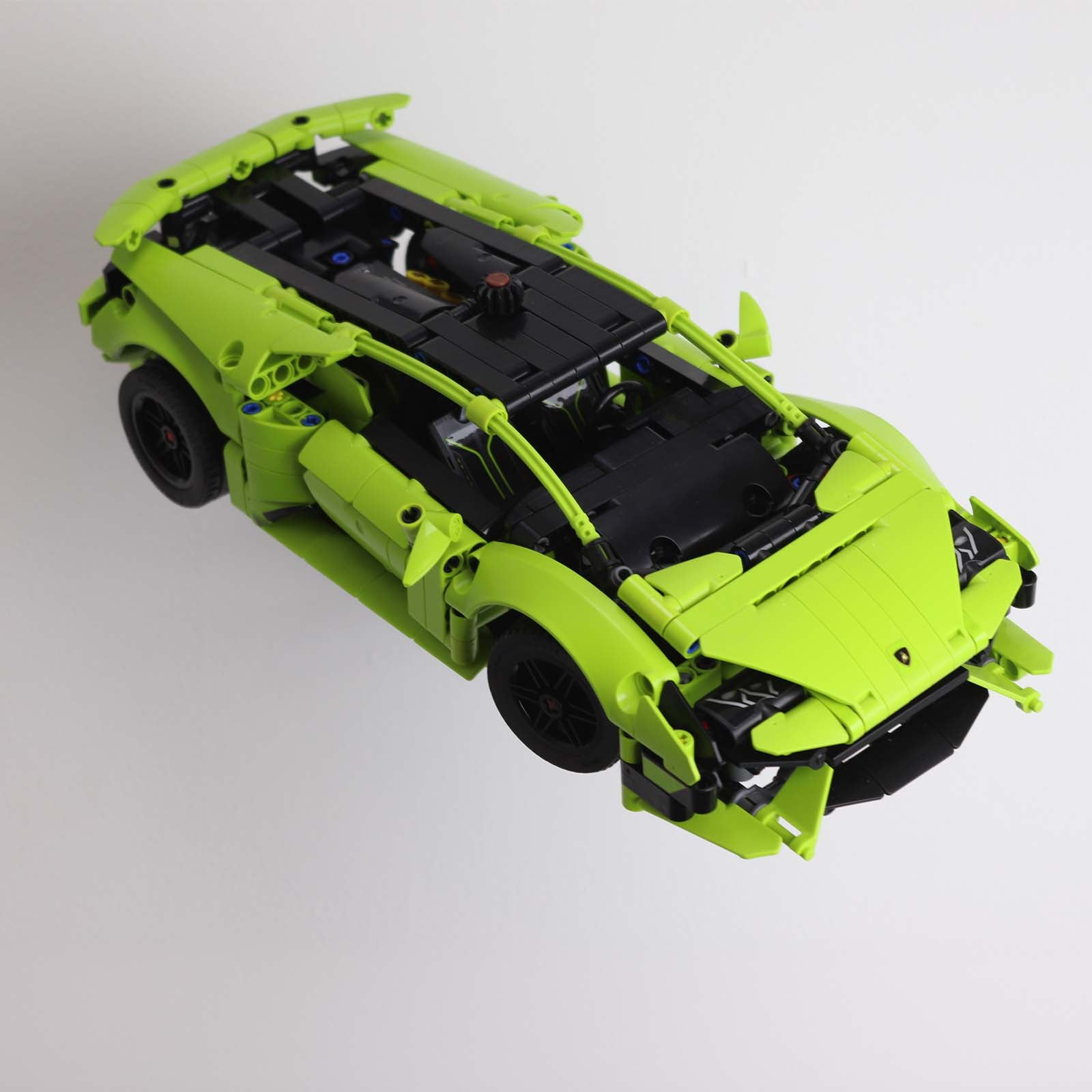 Wall mount display stand holding LEGO® Lamborghini Huracán models 42161 and 42196, presenting the cars at an angled position on the wall for a striking display.