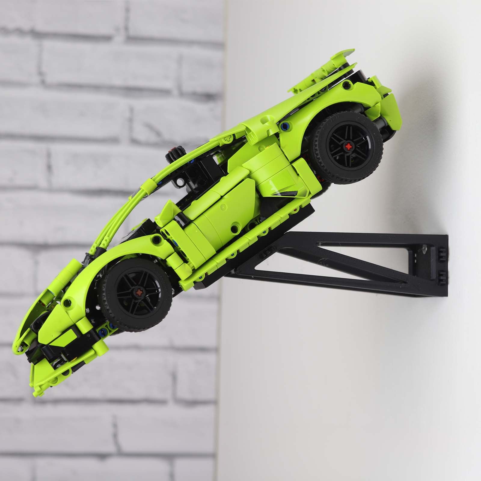 Wall mount display stand holding LEGO® Lamborghini Huracán models 42161 and 42196, presenting the cars at an angled position on the wall for a striking display.