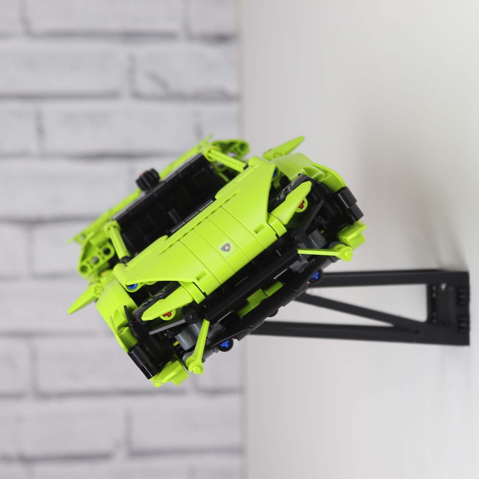 Wall mount display stand holding LEGO® Lamborghini Huracán models 42161 and 42196, presenting the cars at an angled position on the wall for a striking display.