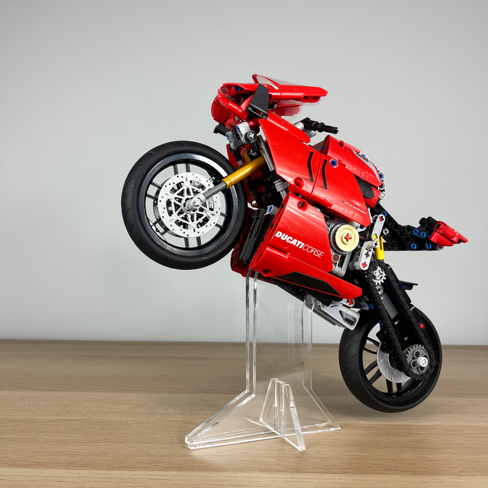 Red Lego Ducati motorcycle model on a clear stand acrylic stand
