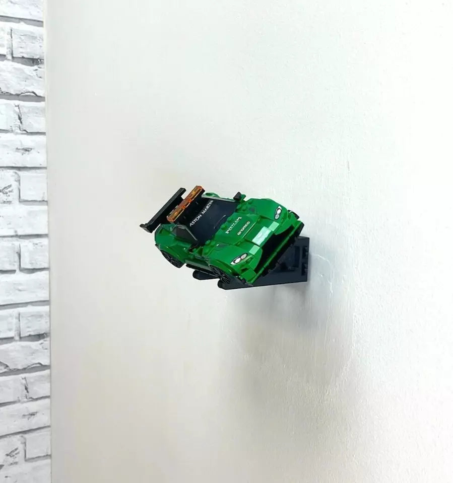 Wall mount display stand holding LEGO® Aston Martin Safety Car & AMR23 (76925) models, showcasing the cars at an angled position on the wall for an eye-catching display.