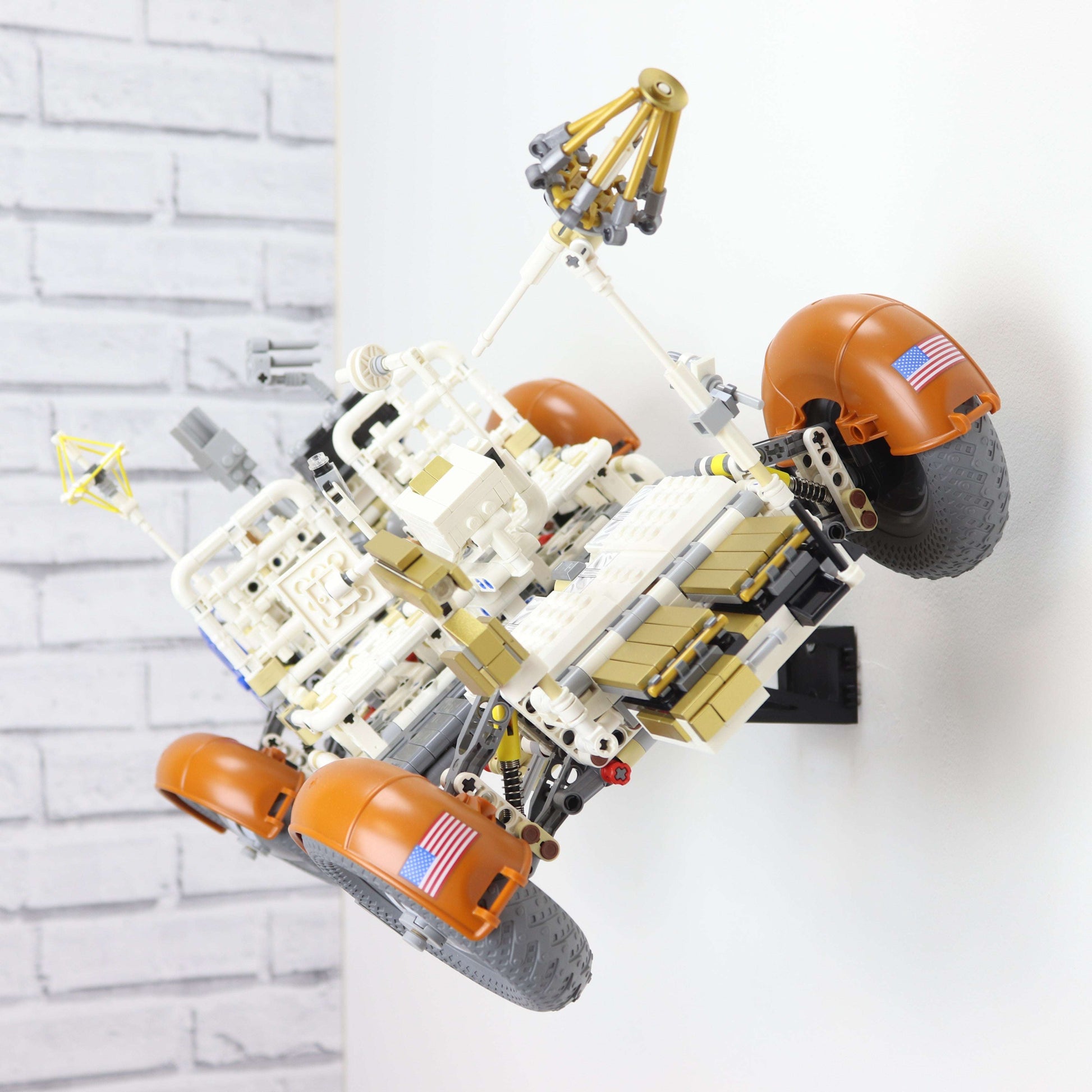 Wall display mount holding LEGO® Lunar Roving Vehicle (LRV 42182) model, showcasing the vehicle at an angled position on the wall for an eye-catching display.