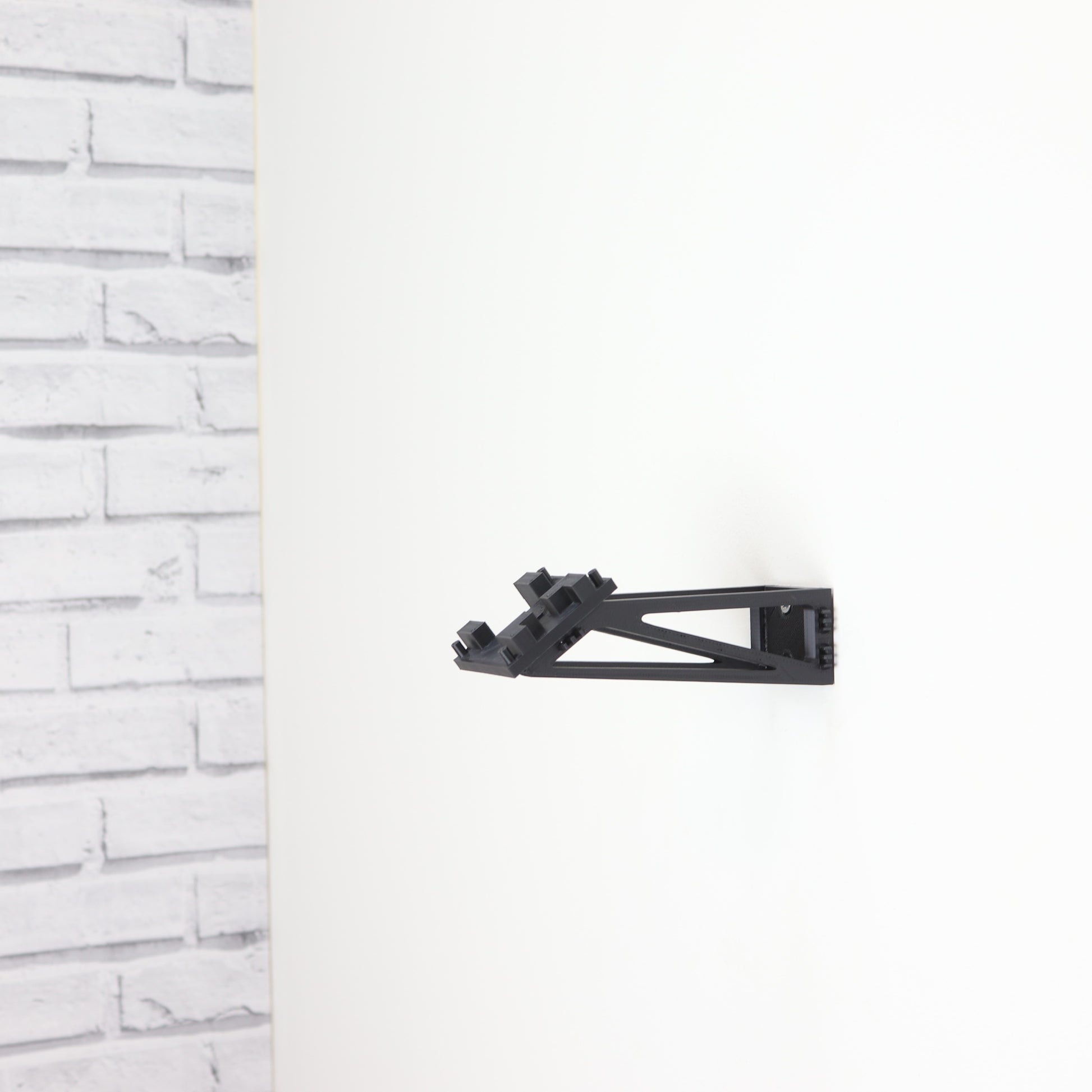 Wall display mount holding LEGO® Lunar Roving Vehicle (LRV 42182) model, showcasing the vehicle at an angled position on the wall for an eye-catching display.