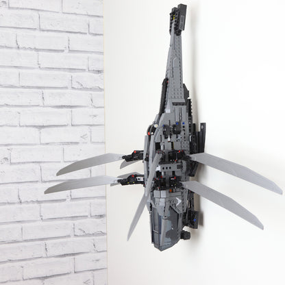 Vertical wall mount display stand holding LEGO® Dune Atreides Royal Ornithopter 10327 model, presenting the aircraft at a dynamic angle on the wall.
