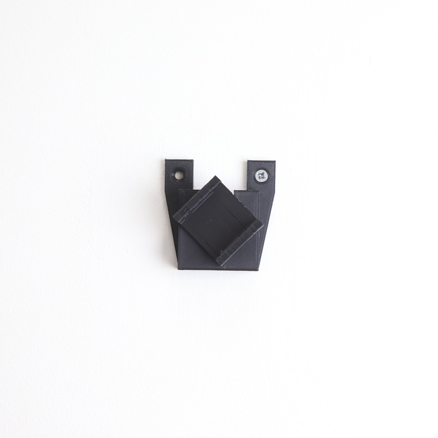 Vertical wall mount display stand holding LEGO® Dune Atreides Royal Ornithopter 10327 model, presenting the aircraft at a dynamic angle on the wall.

