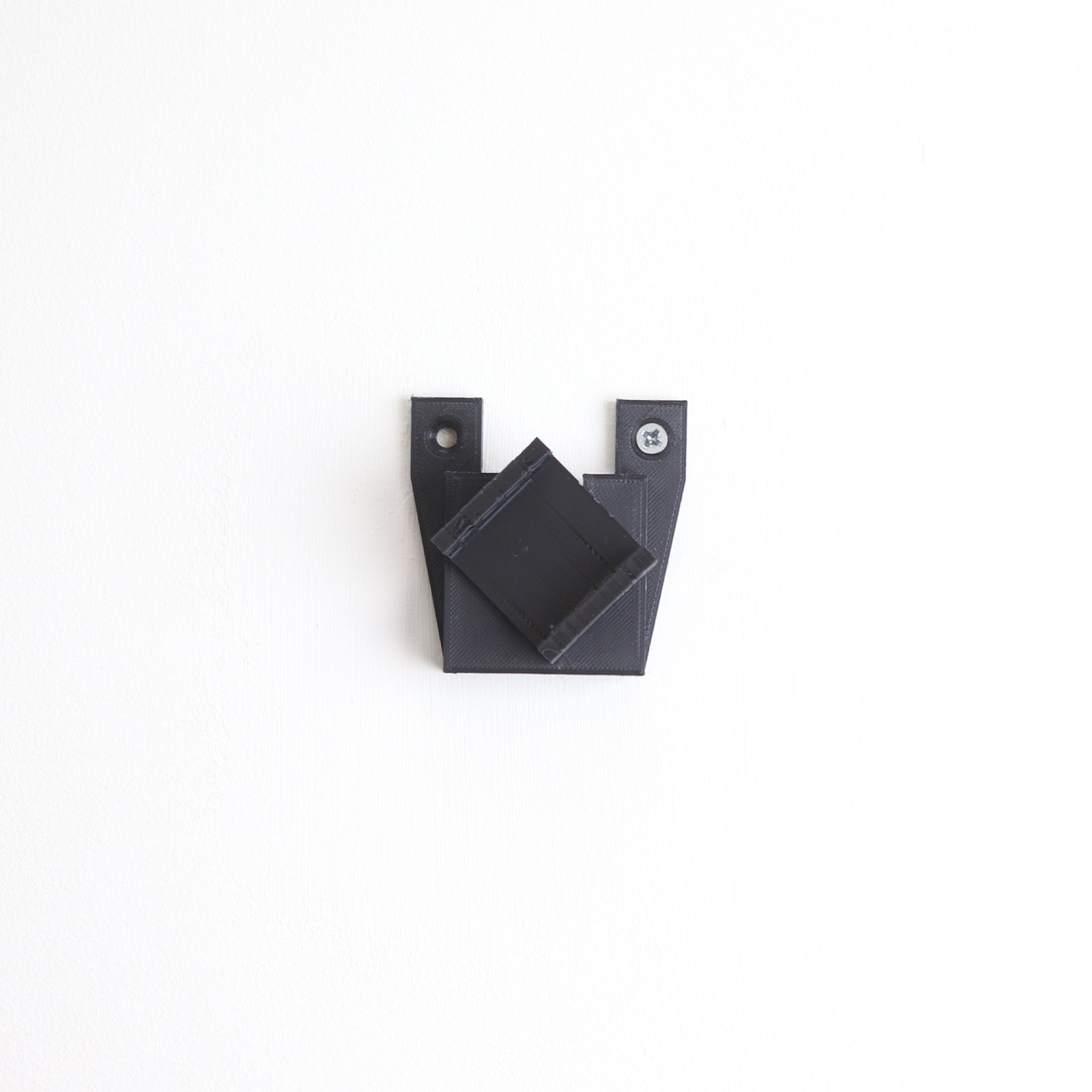 Vertical wall mount display stand holding LEGO® Dune Atreides Royal Ornithopter 10327 model, presenting the aircraft at a dynamic angle on the wall.
