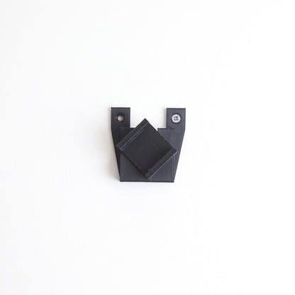 Vertical wall mount display stand holding LEGO® Dune Atreides Royal Ornithopter 10327 model, presenting the aircraft at a dynamic angle on the wall.
