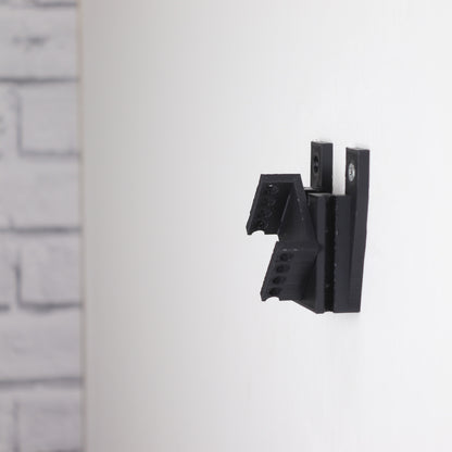 Vertical wall mount display stand holding LEGO® Dune Atreides Royal Ornithopter 10327 model, presenting the aircraft at a dynamic angle on the wall.

