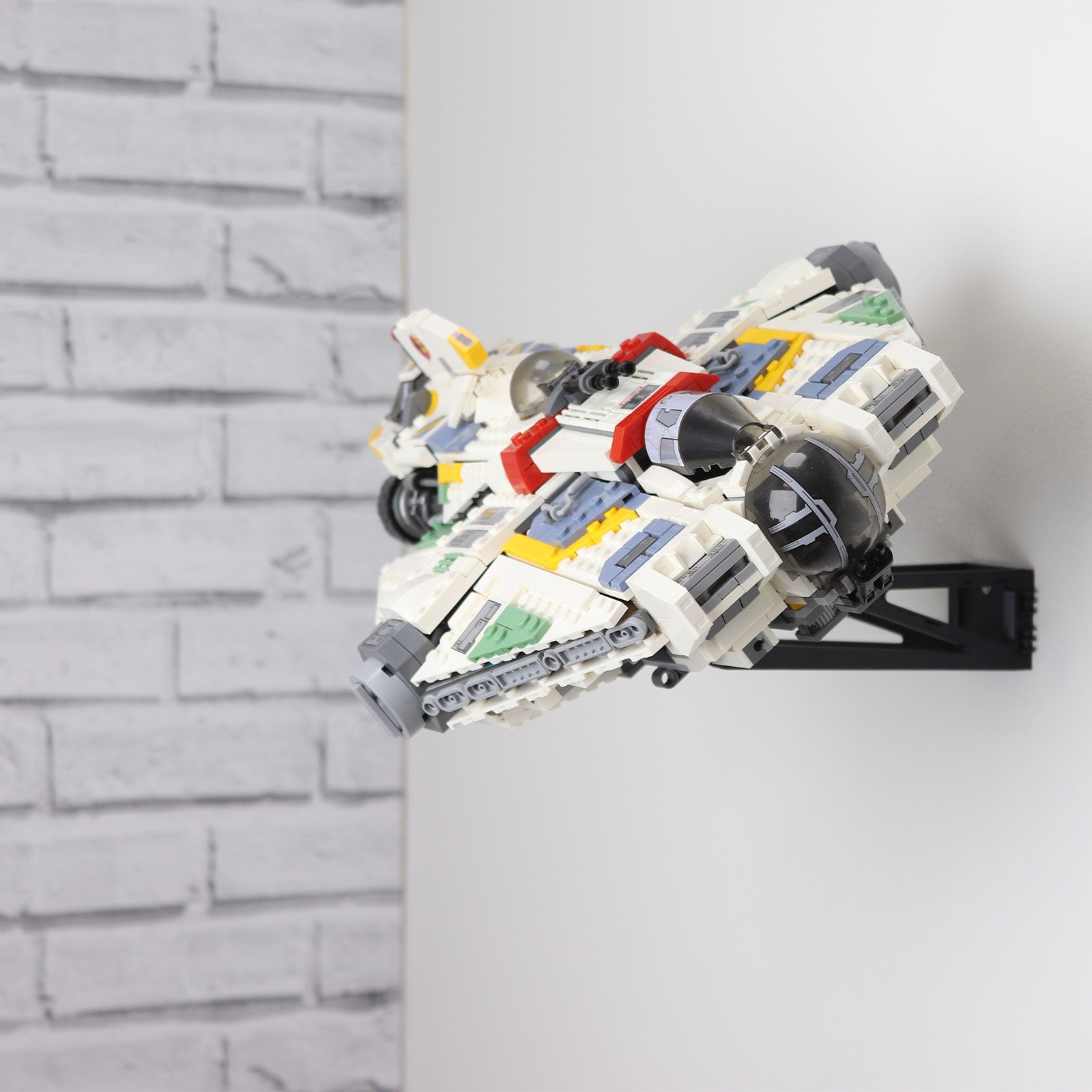 Wall mount display stand holding LEGO® Ghost & Phantom II (75357) models, showcasing the ships at an angled position on the wall for an impressive visual presentation.
