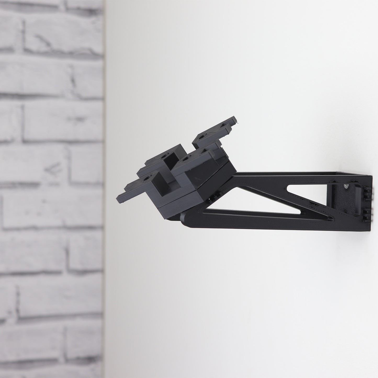 Wall mount display stand holding LEGO® Ghost & Phantom II (75357) models, showcasing the ships at an angled position on the wall for an impressive visual presentation.
