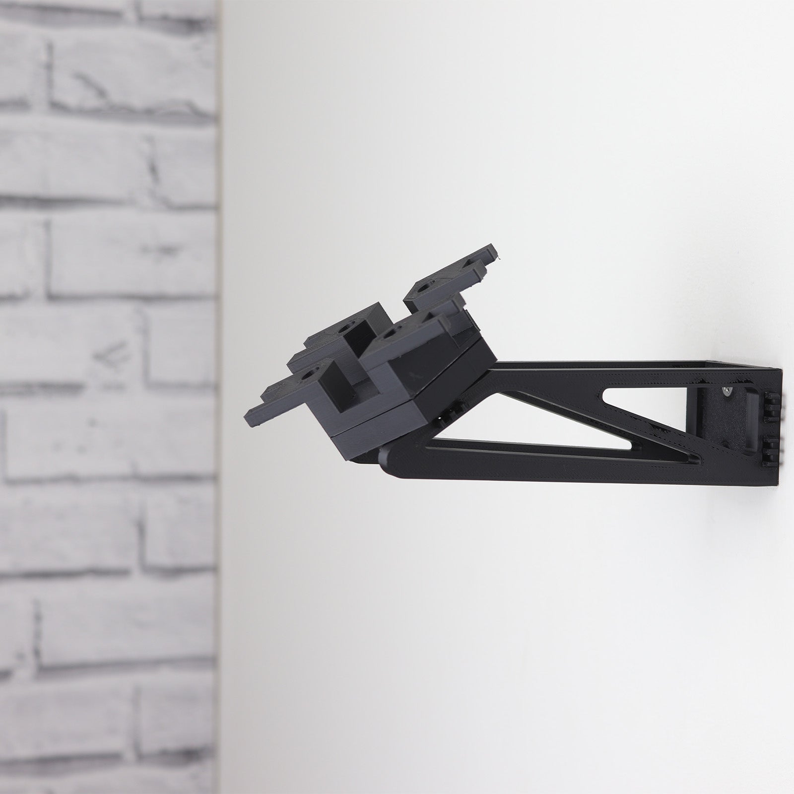 Wall mount display stand holding LEGO® Ghost & Phantom II (75357) models, showcasing the ships at an angled position on the wall for an impressive visual presentation.
