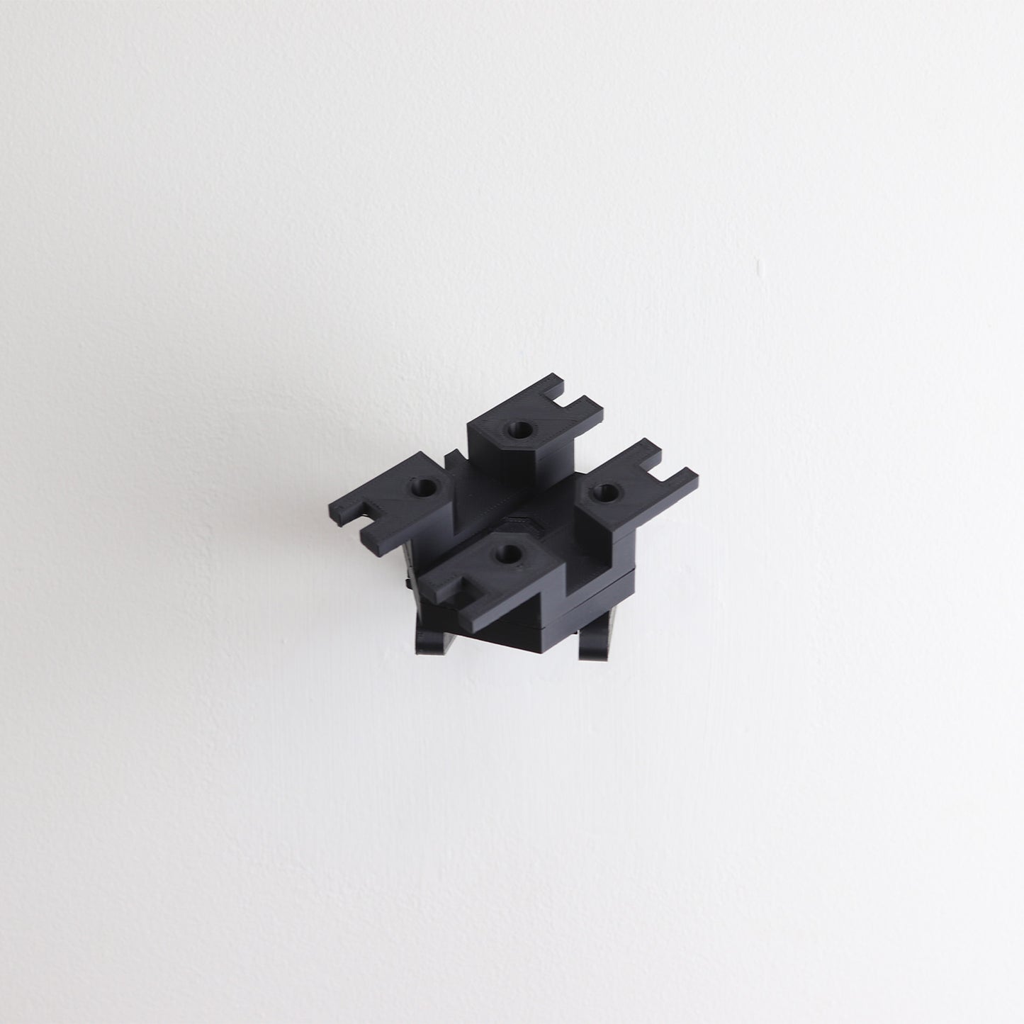 Wall mount display stand holding LEGO® Ghost & Phantom II (75357) models, showcasing the ships at an angled position on the wall for an impressive visual presentation.
