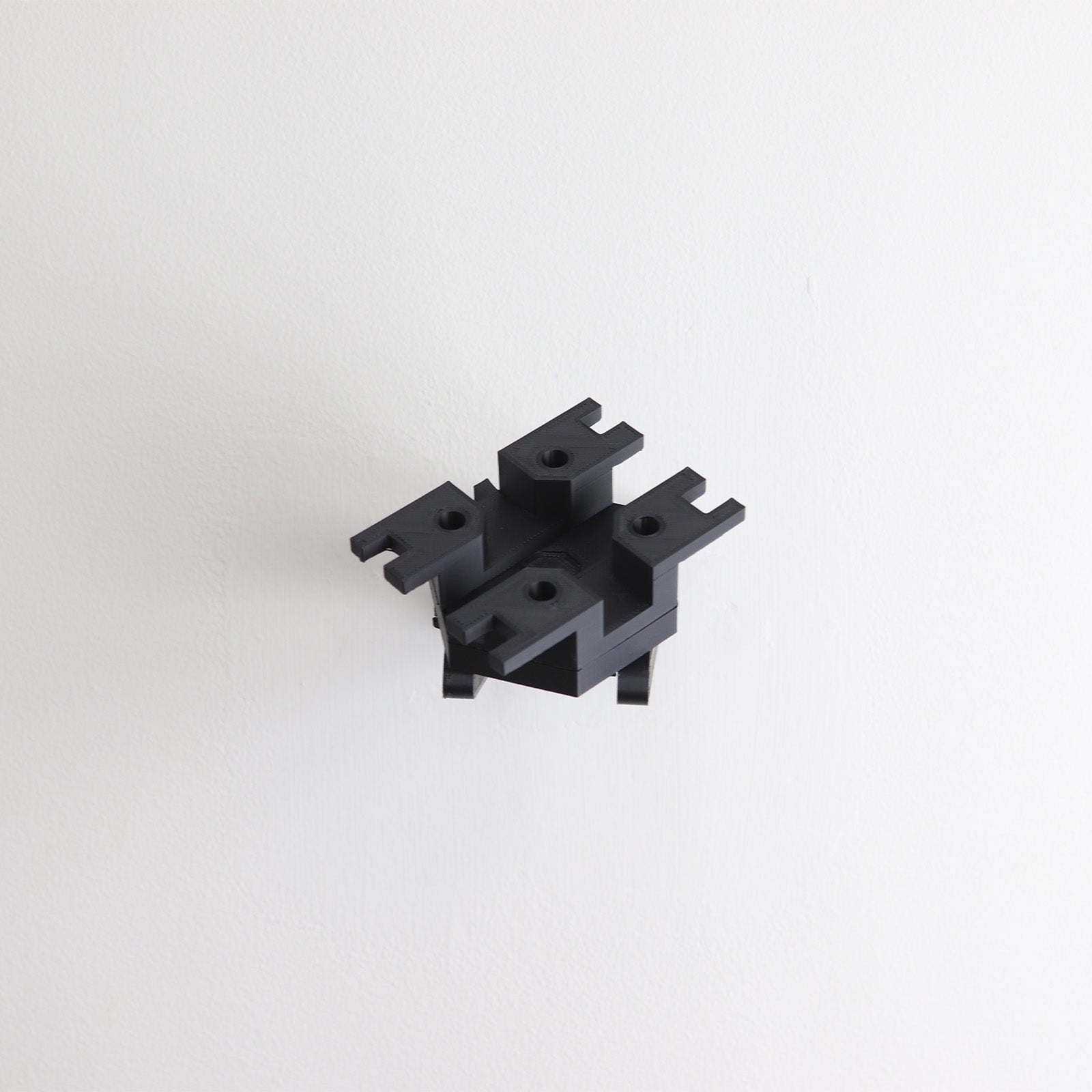 Wall mount display stand holding LEGO® Ghost & Phantom II (75357) models, showcasing the ships at an angled position on the wall for an impressive visual presentation.
