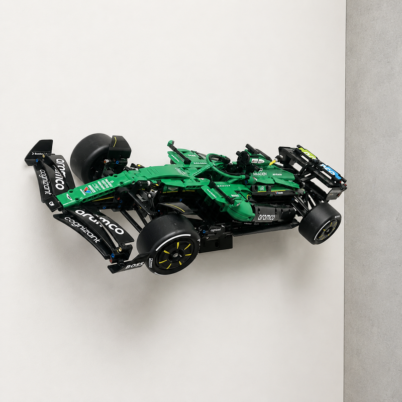 LEGO Technic Aston Martin Aramco AMR25 F1 Car 42240 displayed at a dynamic angle on a black BrickNest wall mount against a clean white wall