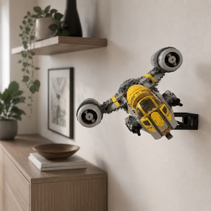 LEGO Star Wars The Razor Crest 75447 shown on a BrickNest wall display mount, creating a clean space-saving starship display for LEGO collectors and Mandalorian fans. The mount presents the model in a wall-mounted flying position, making it ideal for bedrooms, offices, gaming rooms, Star Wars themed rooms, LEGO display walls and collector setups. Compatible display accessory only, LEGO model not included.
