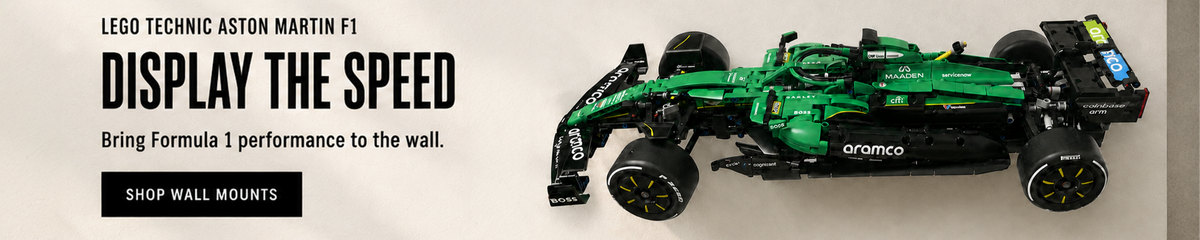 LEGO Aston Martin Formula 1 car displayed on a BrickNest wall mount in a modern motorsport-themed interior