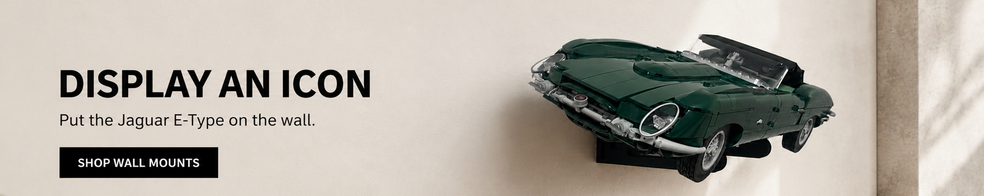 LEGO Icons Jaguar E-Type displayed on a BrickNest wall mount as a space-saving feature in a collector's room