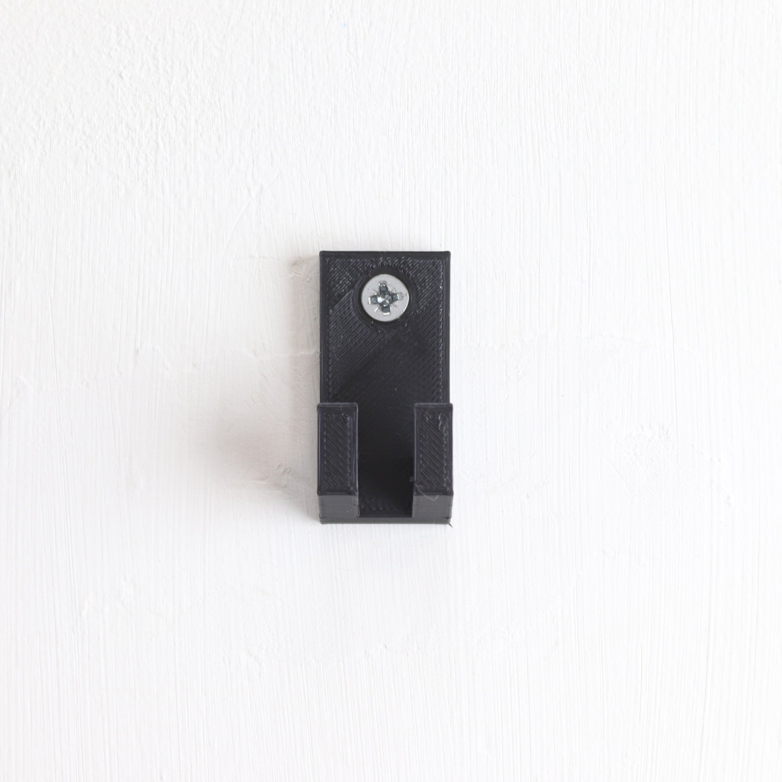 Vertical wall display mount holding LEGO® Technic Mercedes F1 Car 42171 model, showcasing the car at an angled position on the wall.
