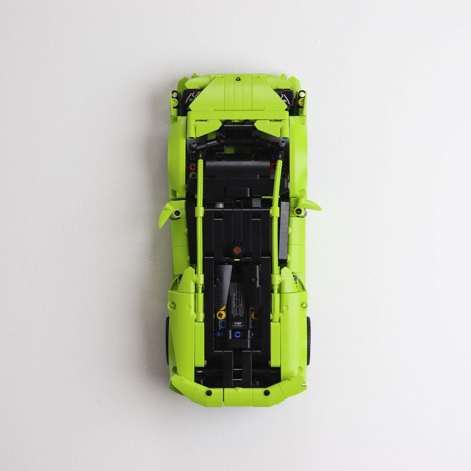 Vertical wall mount display stand holding LEGO® Lamborghini Huracán models 42161 and 42196, presenting the cars at an angled position on the wall for optimal display.
