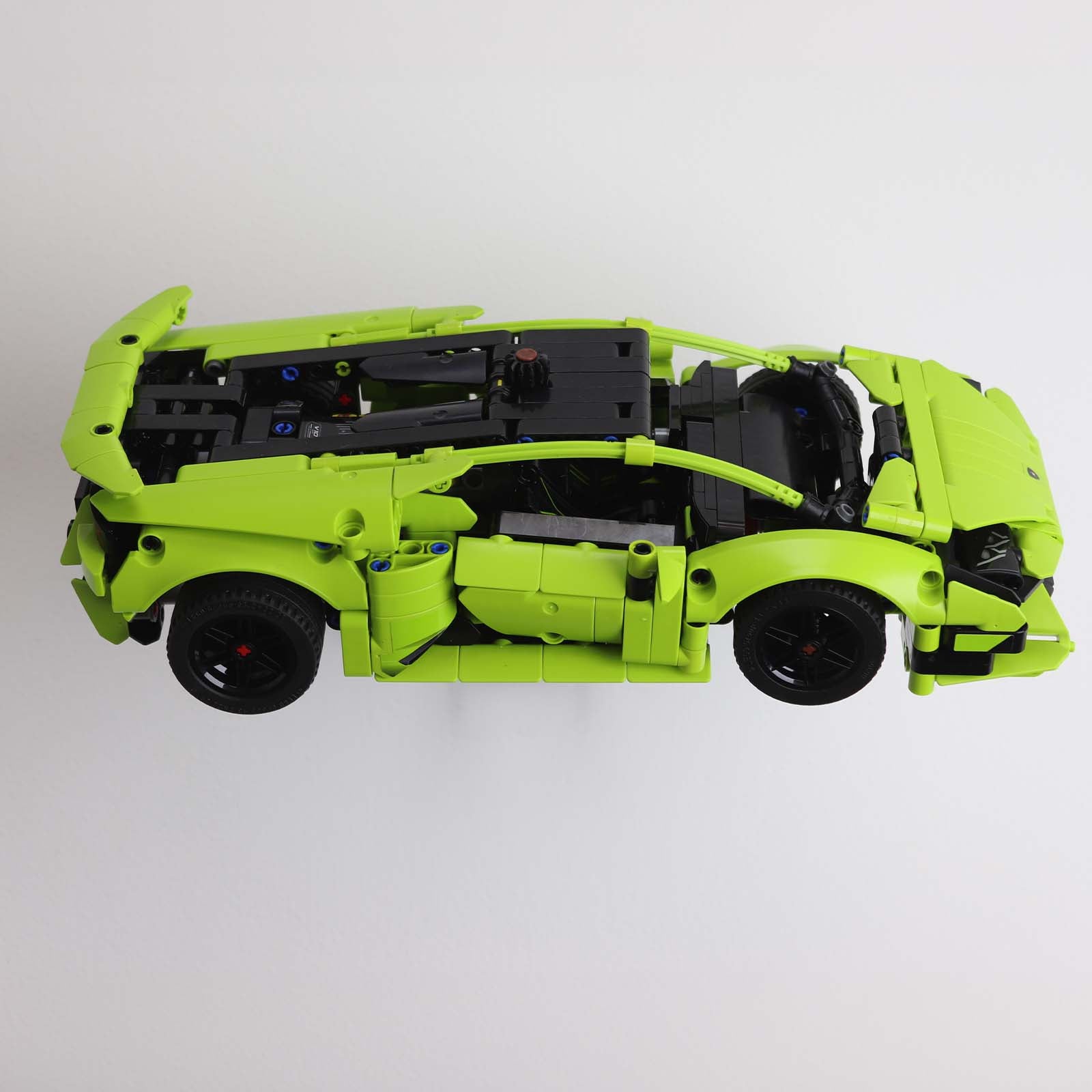 Wall mount display stand holding LEGO® Lamborghini Huracán models 42161 and 42196, presenting the cars at an angled position on the wall for a striking display.
