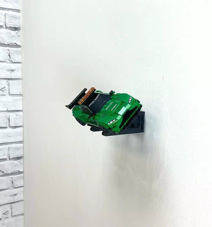Wall mount display stand holding LEGO® Aston Martin Safety Car & AMR23 (76925) models, showcasing the cars at an angled position on the wall for an eye-catching display.
