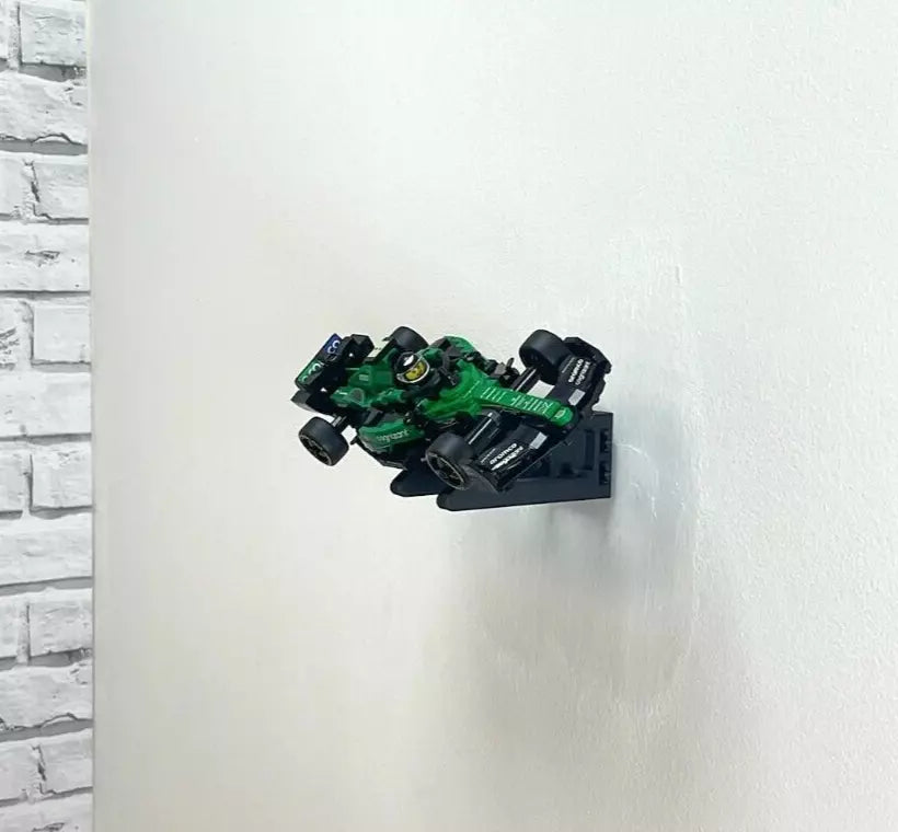 Wall mount display stand holding LEGO® Aston Martin Safety Car & AMR23 (76925) models, showcasing the cars at an angled position on the wall for an eye-catching display.
