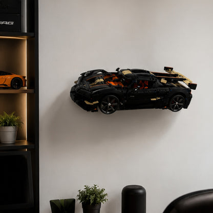Angled LEGO Technic Koenigsegg wall display on a white wall