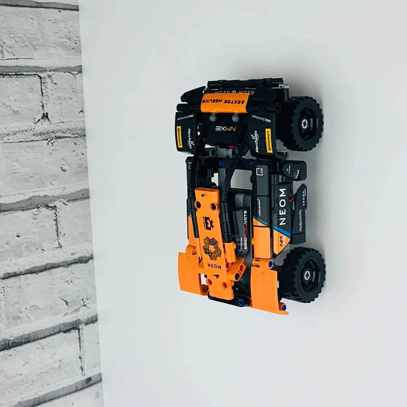 Wall display mount holding LEGO® McLaren Neom Extreme E Race Car (42166) model, displaying the car at an angled position on the wall for an impressive presentation.
