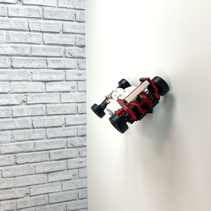 Wall display mount holding LEGO® McLaren MP4/4 & Ayrton Senna (10330) model, showcasing the car at an angled position on the wall for an eye-catching display.
